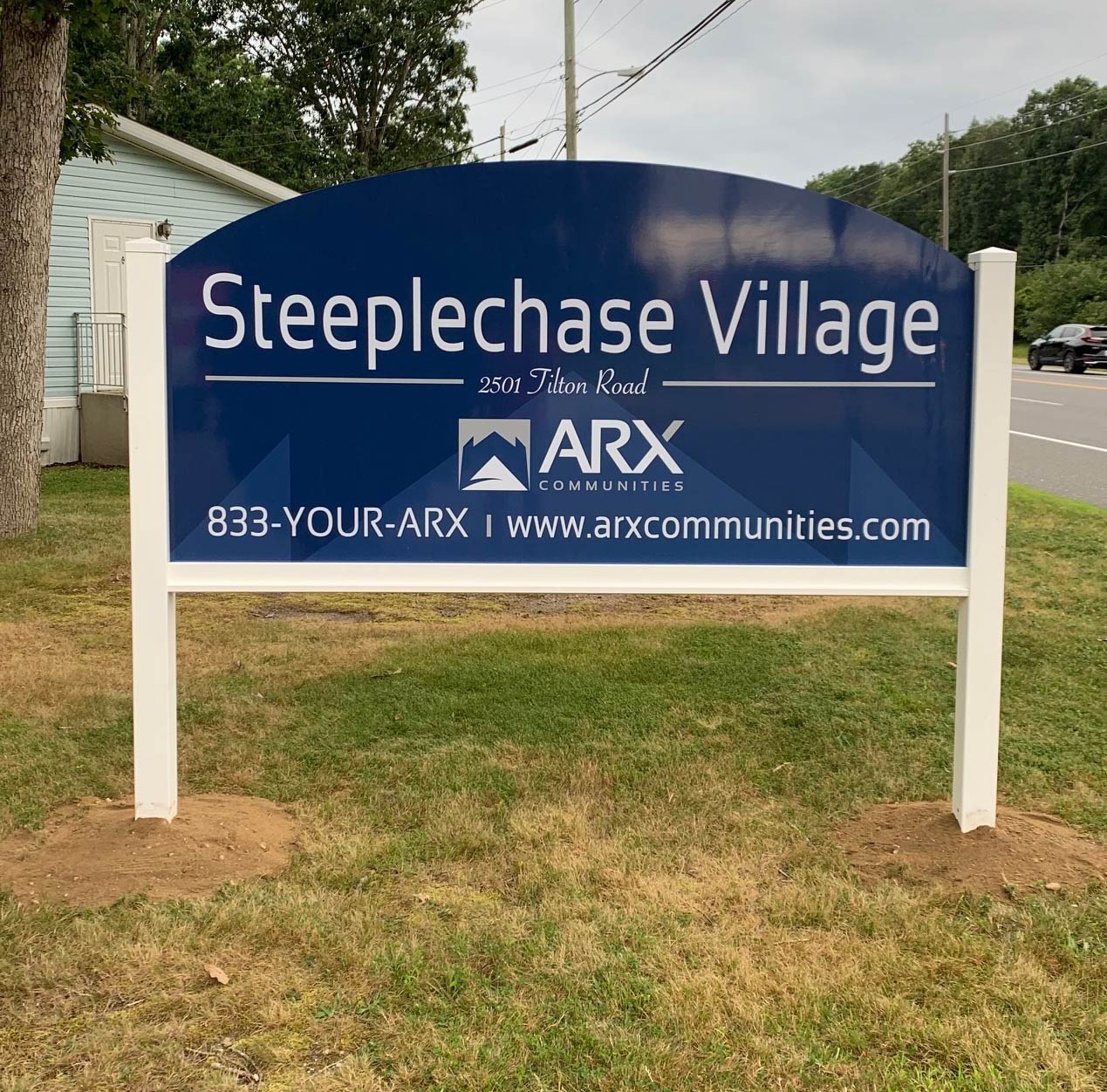 Commercial property sign displayed in a finished freestanding frame.