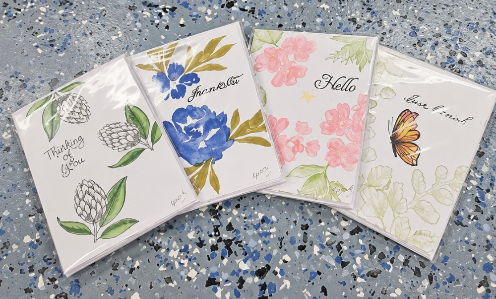 Four handmade floral greeting cards with watercolor flowers and butterfly designs.