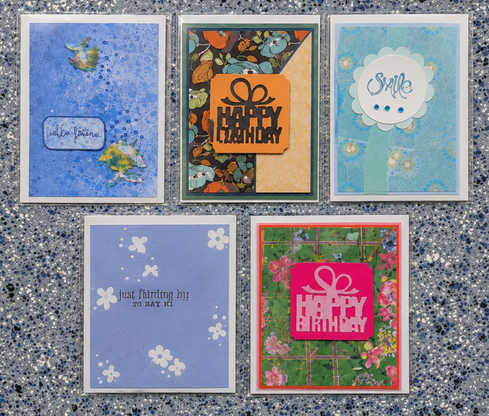Five layered handmade greeting cards with birthday, friendship, and decorative paper designs.