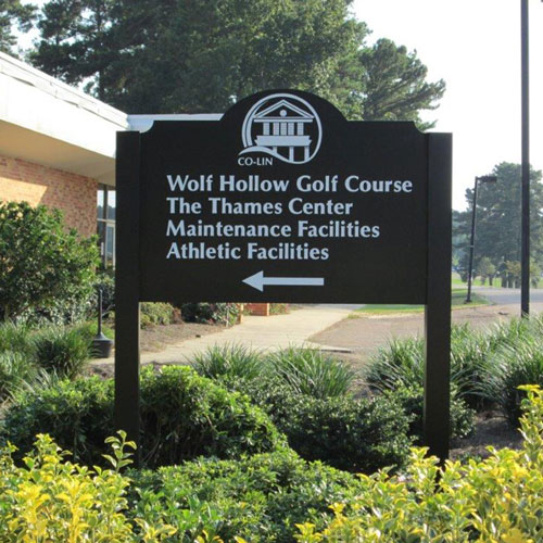 Ornamental community sign system with decorative posts and framing.