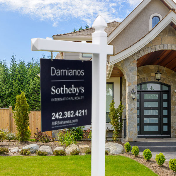 Residential real estate listing sign mounted on a post system.